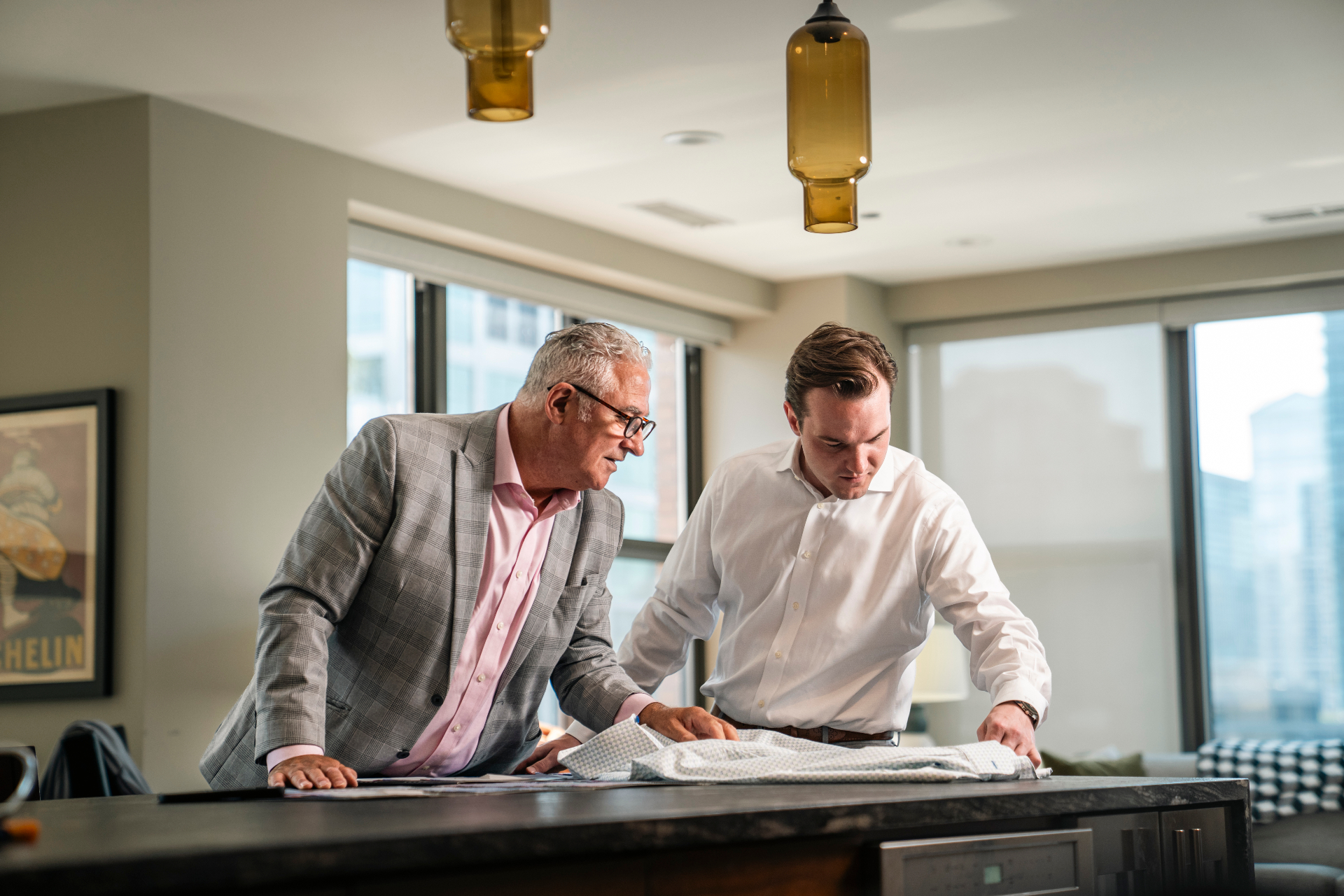 Daniel consulting with a client over fabric selections in a private fitting