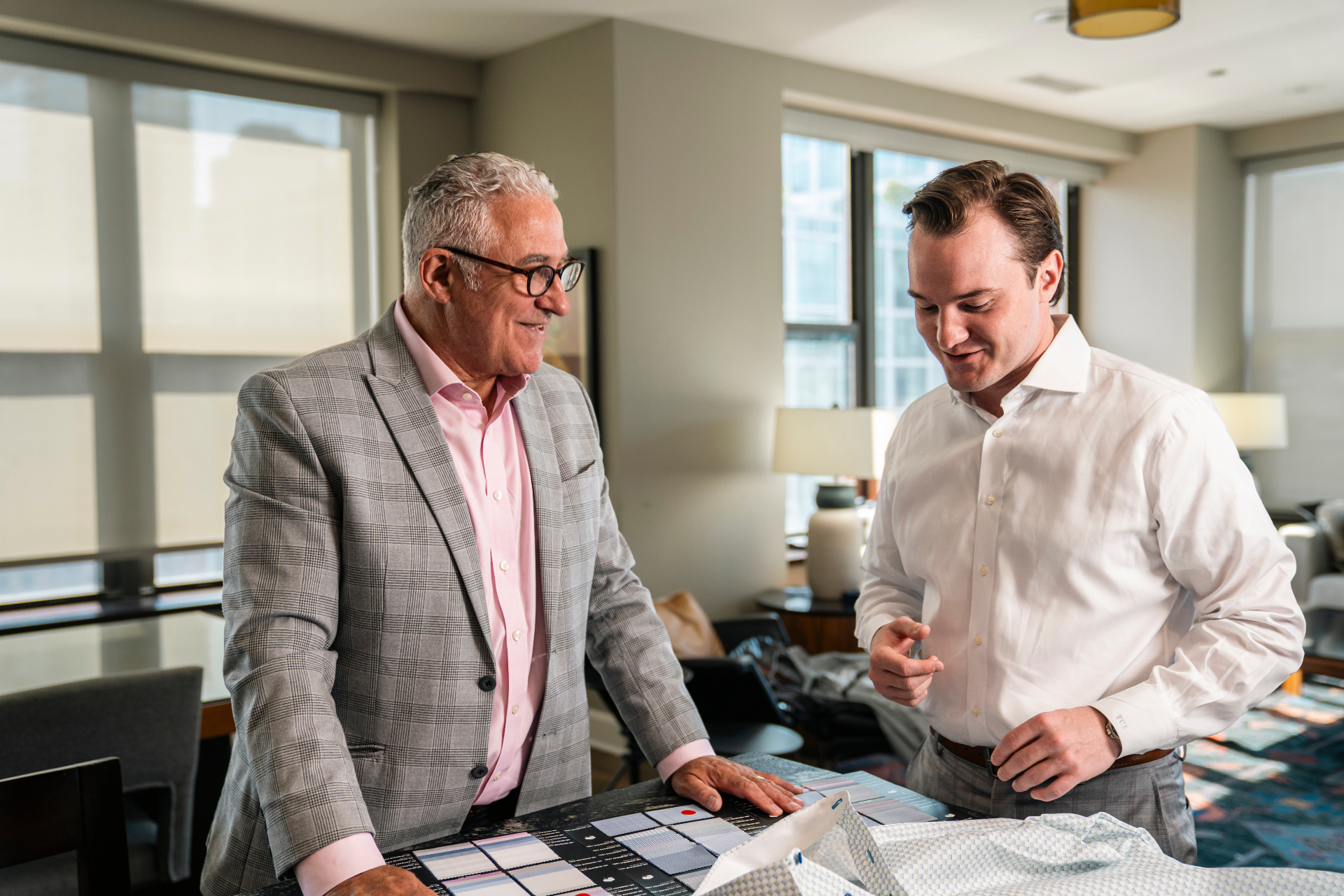 Tailor reviewing fabric swatches with a client